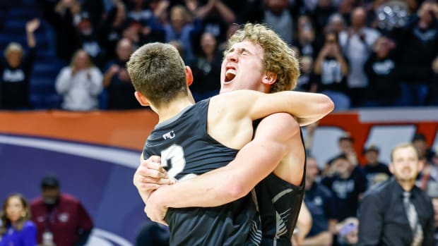 Chance Little hugs Mason Berry as West Central celebrates winning the 2024 Illinois Class 1A boys basketball championship